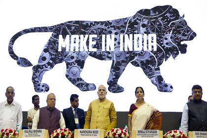 Indian Prime Minister Narendra Modi, center, unveils the logo of 'Make in India' initiative in New Delhi, India, Thursday, Sept. 25, 2014. Scores of business leaders from India and abroad attended the launch of the initiative where in the Indian Prime Minister called on manufacturers across the globe to come and make India a manufacturing hub. (AP Photo/Saurabh Das)