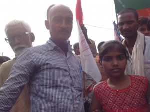 Manoj Kumar Singh and his niece at the rally. He is a teacher of math for classes 1 - 8, with a son in the merchant navy. He commutes on a motorbike and says that though this crowd comprises of Manjhi supporters, the Maha Dalits, he believes the voter should move beyond caste to the state's broader development.