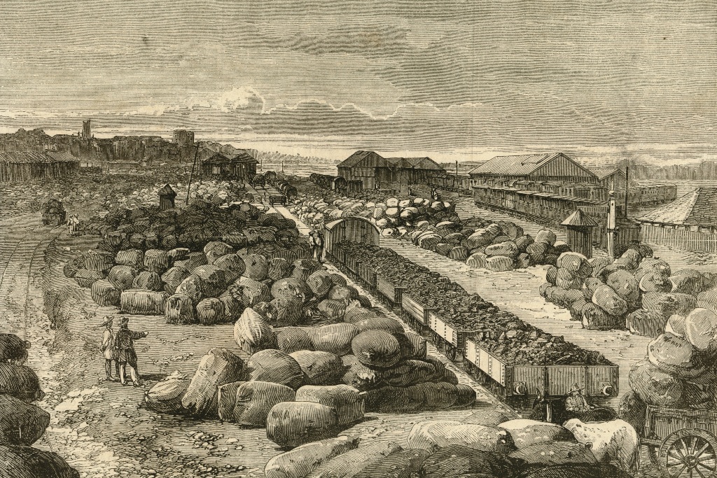 An image of cotton bales lying strewn at the Bombay terminus of the Great Indian Peninsula Railway. Cotton from Bombay's hinterland began the Bombay-China trade and remained its mainstay since the 18th century. Photo courtesy: Dr. Jehangir Sorabjee