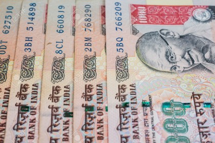 A stack of one thousand rupee notes.