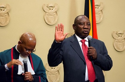 South Africa's new president Cyril Ramaphosa (R) holds up his right hand as he is sworn into office by South Africa's Chief Justice Mogoeng Mogoeng (L) after being elected by the Members of Parliament at the Parliament in Cape Town, on February 15, 2018.

South African lawmakers elected wealthy former businessman Cyril Ramaphosa on February 15, 2018 as the country's new president after scandal-tainted Jacob Zuma resigned under pressure from his own ANC ruling party. Ramaphosa was elected without a vote after being the only candidate nominated in the parliament in Cape Town, chief justice Mogoeng Mogoeng told assembled lawmakers.
 / AFP PHOTO / POOL / Rodger BOSCH
