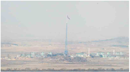 Photo 6: A view of North Korea – the flag and the propaganda village (give credit to the source)