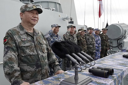 FILE - In this April 12, 2018, file photo released by Xinhua News Agency, Chinese President Xi Jinping, left, speaks after he reviewed the Chinese People's Liberation Army (PLA) Navy fleet in the South China Sea. From Asia to Africa, London to Berlin, Chinese envoys have set off diplomatic firestorms with a combative defense whenever their country is accused of not acting quickly enough to stem the spread of the coronavirus pandemic. (Li Gang/Xinhua via AP, File)