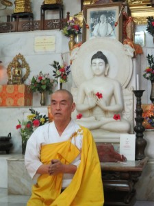 Bhikshu Morita San of the Nipponzan Myohoji Temple (Worli, Mumbai) seated in front of the altar of the only Japanese Temple in Mumbai